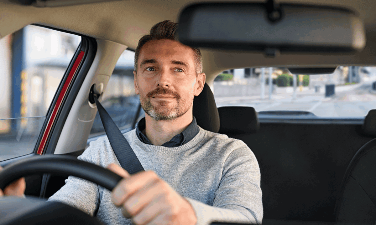Man Driving Car Looking In Mirror.