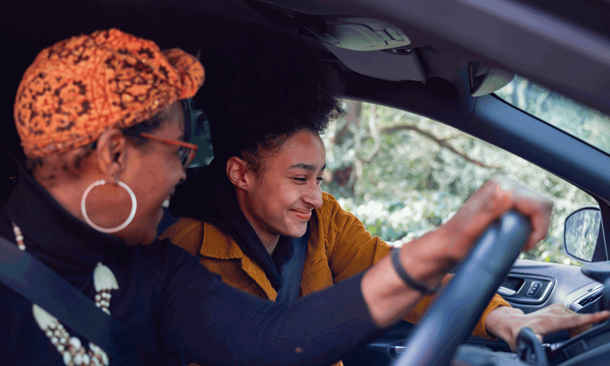 Two women laughing in a car.png